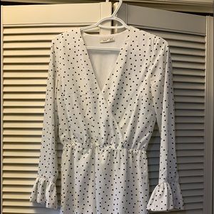 White with black polkadots. Long flowing sleeves
